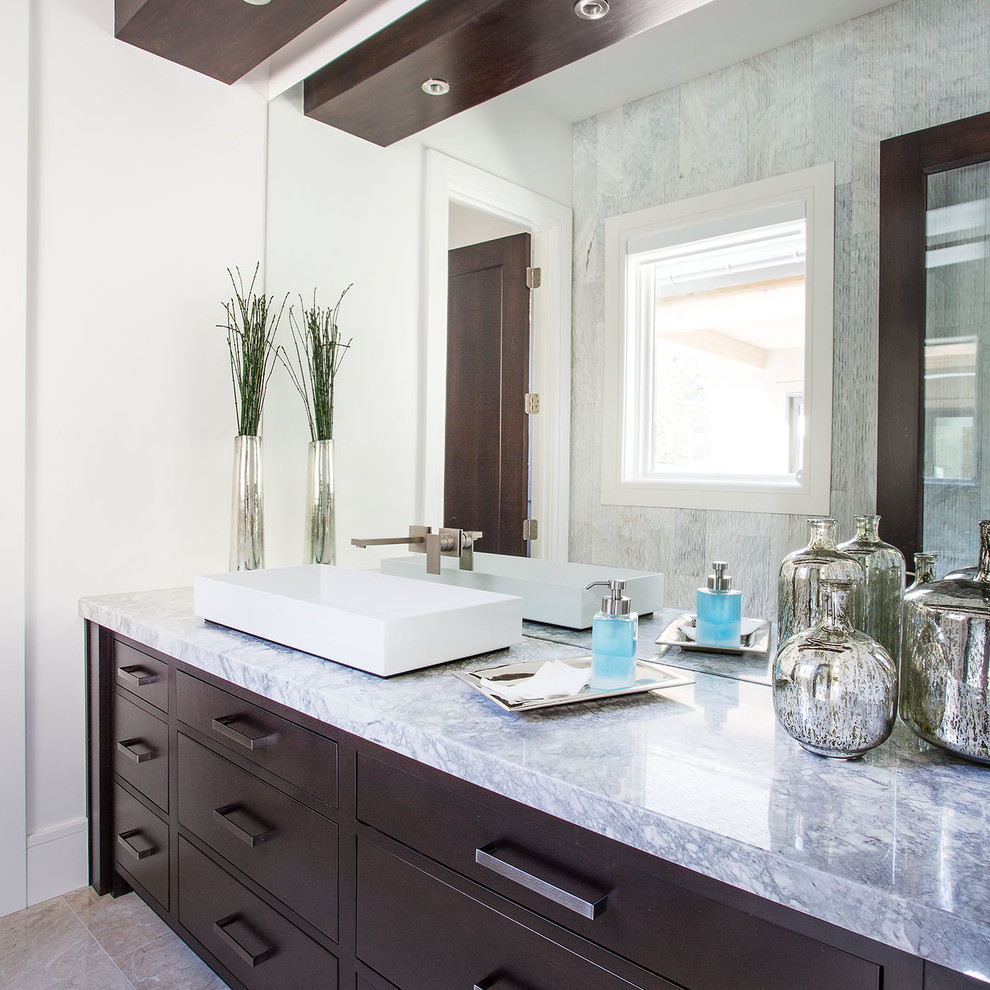Design ideas for a large contemporary master bathroom in Salt Lake City with flat-panel cabinets, dark wood cabinets, gray tile, white walls, a vessel sink, mirror tile, porcelain floors and marble benchtops.