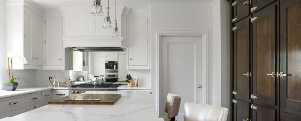 Design ideas for a mid-sized transitional u-shaped separate kitchen in New York with shaker cabinets, white cabinets, marble benchtops, white splashback, marble splashback and with island.