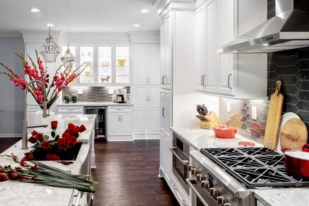 Inspiration for a large transitional single-wall brown floor eat-in kitchen remodel in Atlanta with a farmhouse sink, raised-panel cabinets, white cabinets, quartz countertops, gray backsplash, ceramic backsplash, stainless steel appliances, an island and multicolored countertops