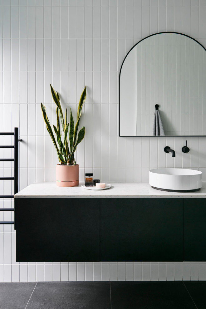 Design ideas for a contemporary bathroom with black cabinets, porcelain tile, white walls, porcelain floors, a vessel sink, engineered quartz benchtops, grey floor, white benchtops, flat-panel cabinets, white tile, a single vanity and a floating vanity.