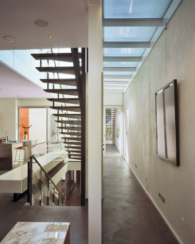 Inspiration for a contemporary wood staircase in San Francisco with mixed railing.