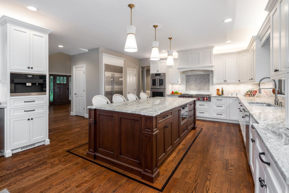 Inspiration for a large transitional l-shaped eat-in kitchen remodel with stainless steel appliances, an island and gray countertops