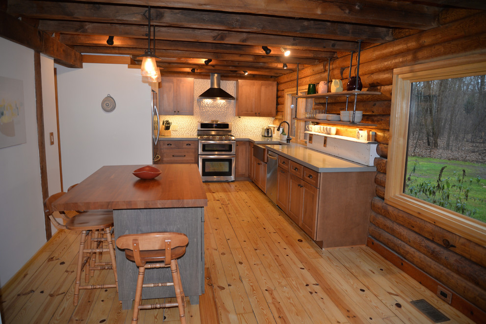 Mid-sized mountain style galley light wood floor kitchen photo in Grand Rapids with an undermount sink, recessed-panel cabinets, medium tone wood cabinets, solid surface countertops, white backsplash, stainless steel appliances and an island