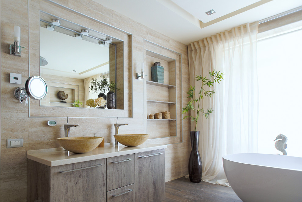 Photo of a mid-sized beach style master bathroom in Moscow with medium wood cabinets, a freestanding tub, beige tile, porcelain tile, beige walls, porcelain floors, a vessel sink, solid surface benchtops, beige benchtops, flat-panel cabinets and brown floor.