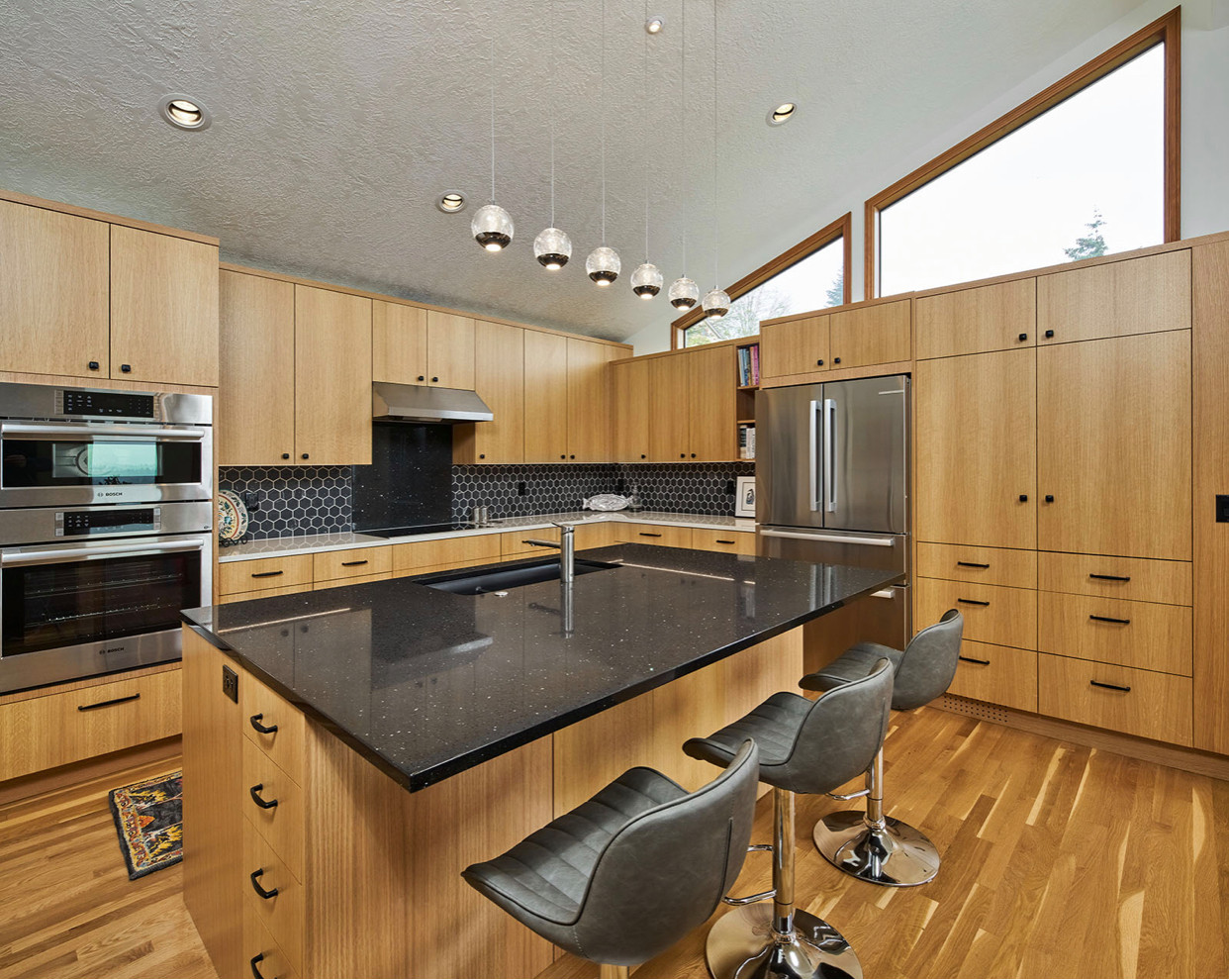 Example of a large l-shaped eat-in kitchen design in Portland with a drop-in sink, open cabinets, light wood cabinets, quartzite countertops, multicolored backsplash, ceramic backsplash, stainless ste