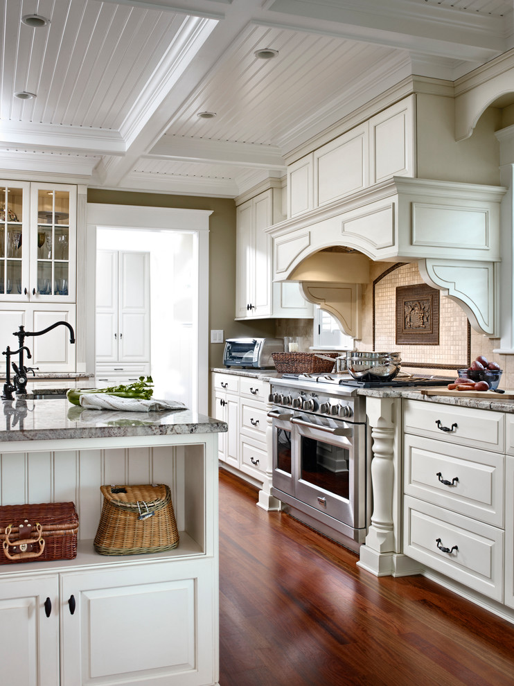 This is an example of a traditional l-shaped eat-in kitchen in Philadelphia with raised-panel cabinets, white cabinets and an undermount sink.