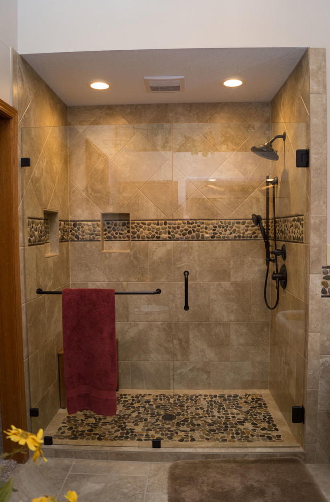 Large southwest master multicolored tile and ceramic tile ceramic tile alcove shower photo in Other with raised-panel cabinets, medium tone wood cabinets, a two-piece toilet, beige walls, an undermount sink and concrete countertops