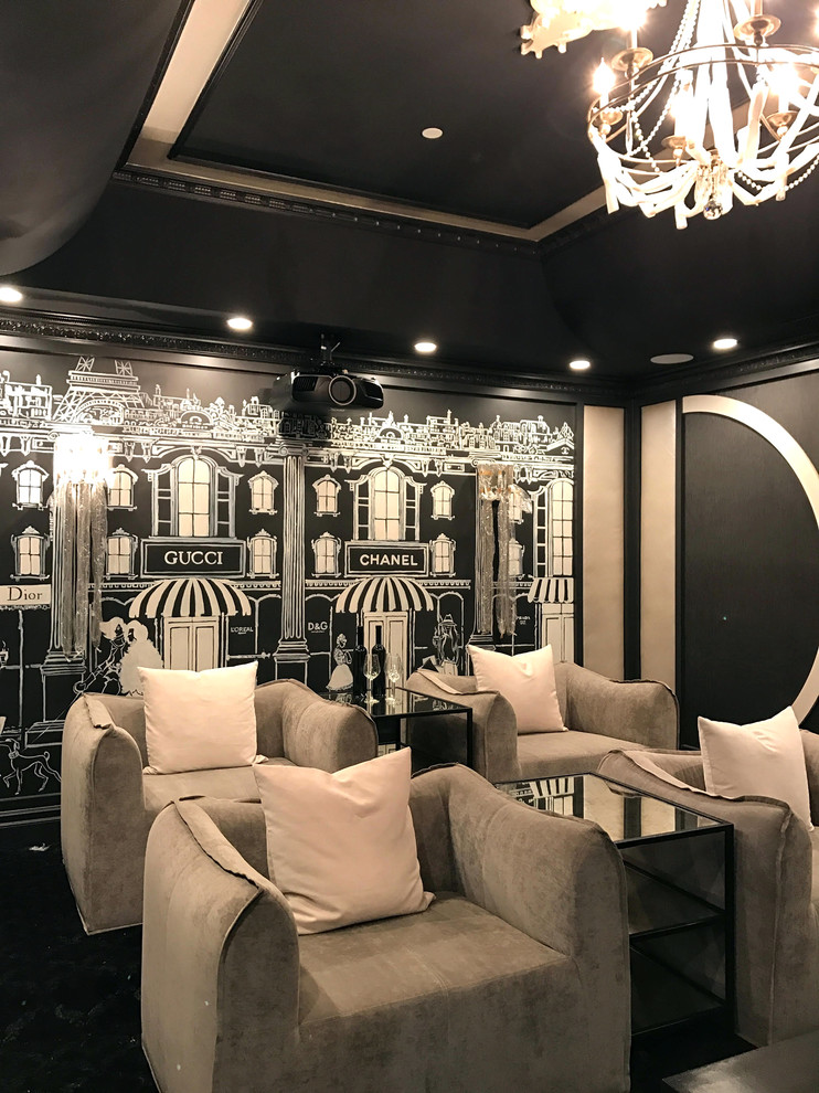 This is an example of a mid-sized traditional home theatre in Los Angeles with black walls, carpet and black floor.