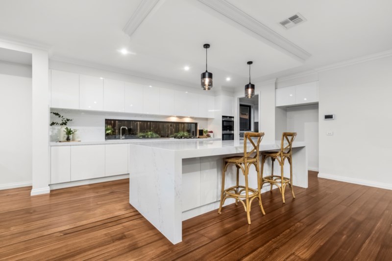 Design ideas for a transitional kitchen in Melbourne with flat-panel cabinets, white cabinets and with island.