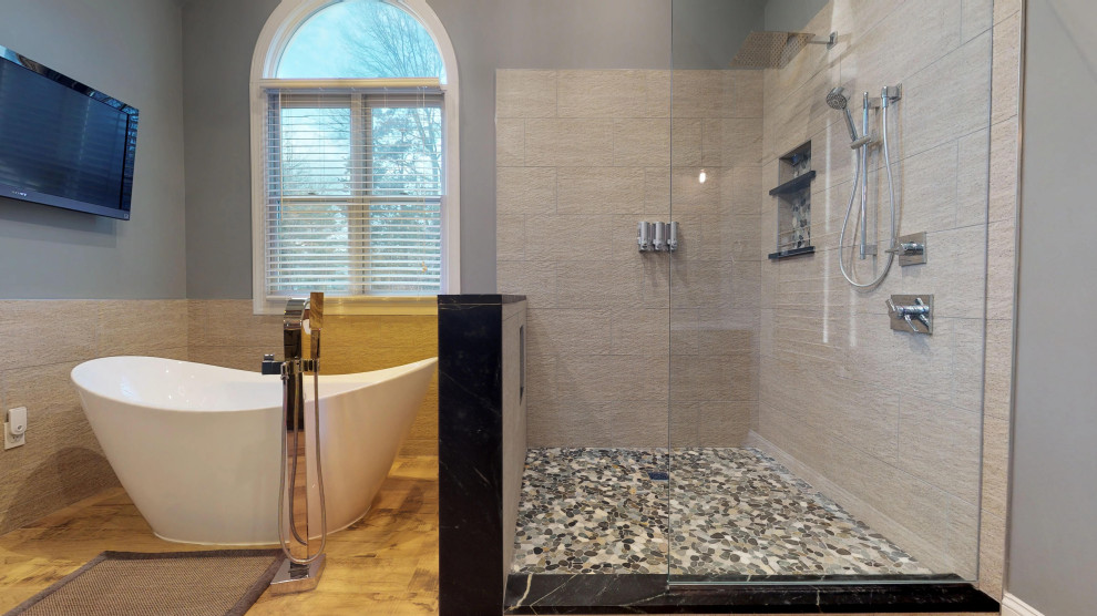 Design ideas for a large traditional master bathroom in Philadelphia with recessed-panel cabinets, dark wood cabinets, a freestanding tub, a corner shower, a two-piece toilet, beige tile, blue walls, laminate floors, a vessel sink, brown floor, an open shower, beige benchtops, a double vanity, a built-in vanity, vaulted and wood walls.