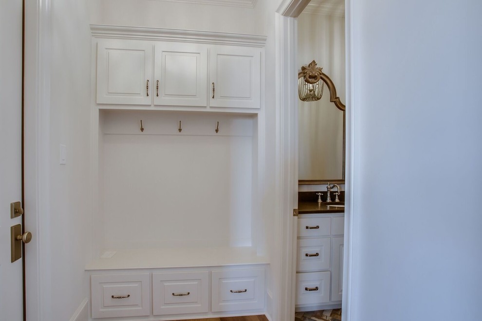 Small transitional mudroom in Austin with white walls, light hardwood floors, a single front door, a white front door and beige floor.