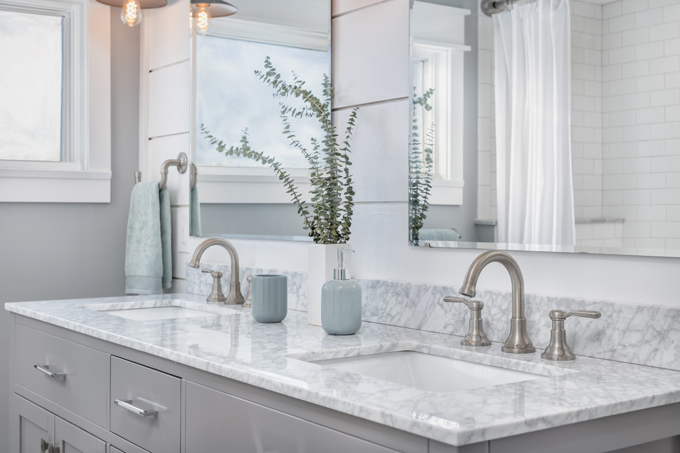 Photo of a small country master bathroom in Boston with shaker cabinets, grey cabinets, an alcove tub, an alcove shower, a two-piece toilet, gray tile, subway tile, grey walls, cement tiles, an undermount sink, marble benchtops, grey floor, a shower curtain and grey benchtops.