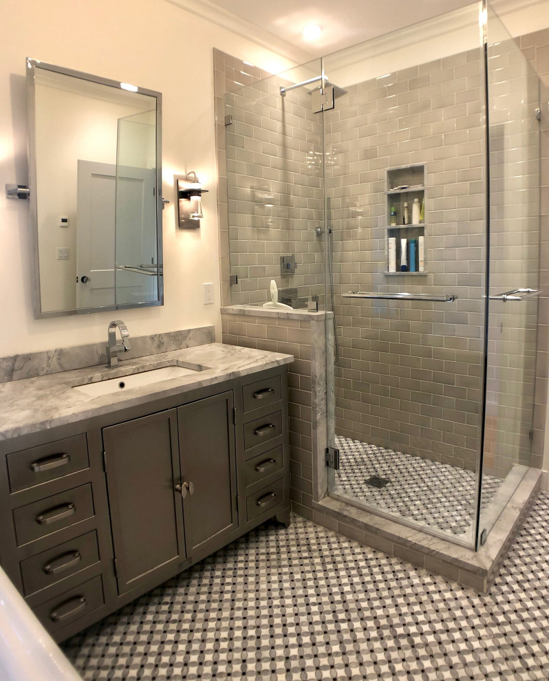 Photo of a large transitional master bathroom in New York with furniture-like cabinets, grey cabinets, a claw-foot tub, a corner shower, a two-piece toilet, gray tile, ceramic tile, white walls, mosaic tile floors, an undermount sink, terrazzo benchtops, multi-coloured floor, a hinged shower door, multi-coloured benchtops, a single vanity, a freestanding vanity and vaulted.
