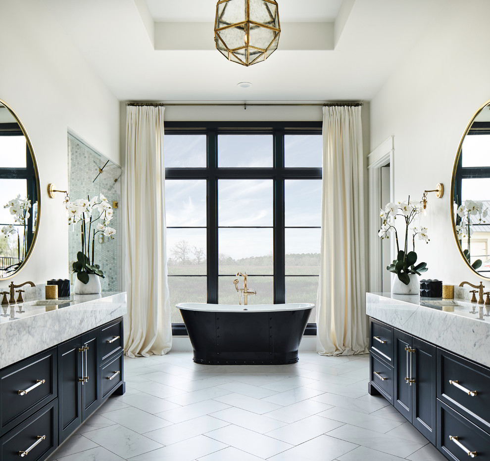 Inspiration for a transitional master bathroom in Austin with recessed-panel cabinets, black cabinets, a freestanding tub, an alcove shower, white walls, porcelain floors, an undermount sink, engineered quartz benchtops, white floor, a hinged shower door and white benchtops.