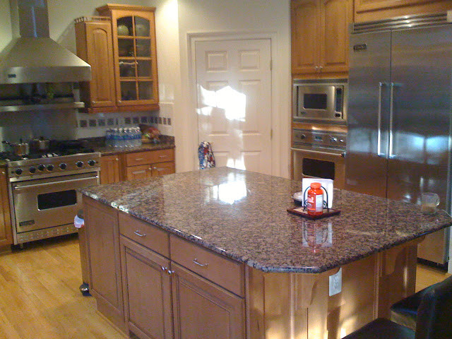 Inspiration for a transitional kitchen remodel in DC Metro with beaded inset cabinets, medium tone wood cabinets, granite countertops, stainless steel appliances and an island