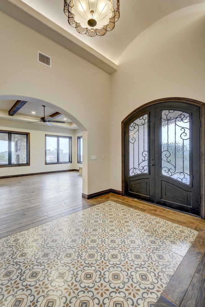 Inspiration for a large transitional foyer in Austin with white walls, porcelain floors, a double front door, a metal front door and multi-coloured floor.