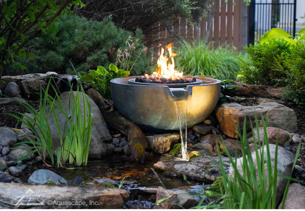 Photo of a small tropical backyard partial sun garden in San Diego with a water feature, a fire feature, a garden path, with pond, with waterfall and river rock.