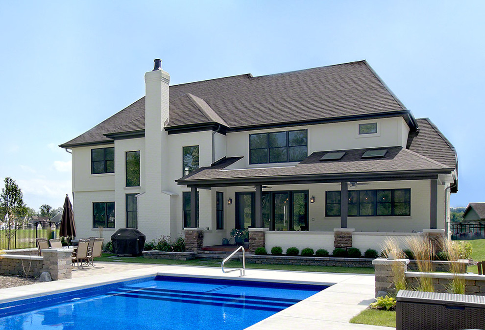 Example of a huge transitional backyard concrete and rectangular lap pool design in Chicago
