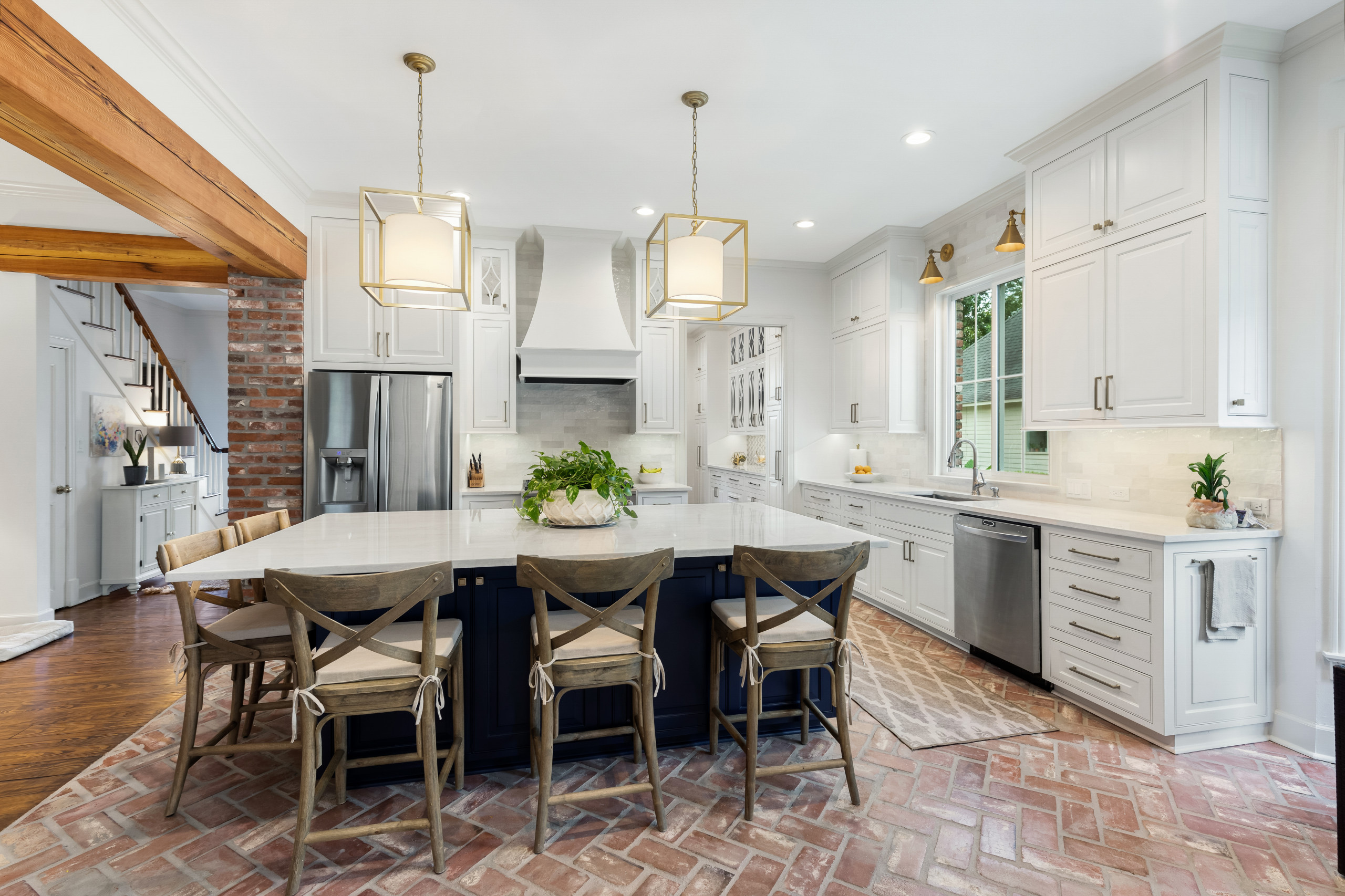 Large elegant l-shaped brick floor and red floor open concept kitchen photo in New Orleans with an undermount sink, raised-panel cabinets, white cabinets, quartzite countertops, gray backsplash, ceram