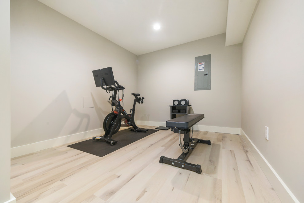 Medium sized modern home gym in Other with white walls, vinyl flooring and beige floors.