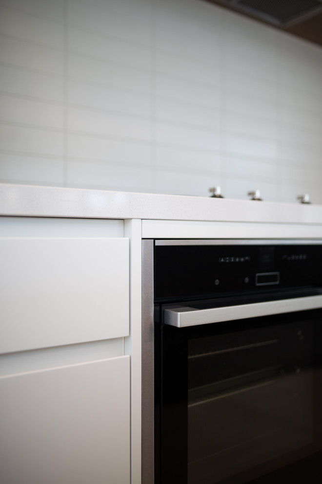 Design ideas for a contemporary open plan kitchen in Sydney with ceramic splashback, ceramic floors and with island.