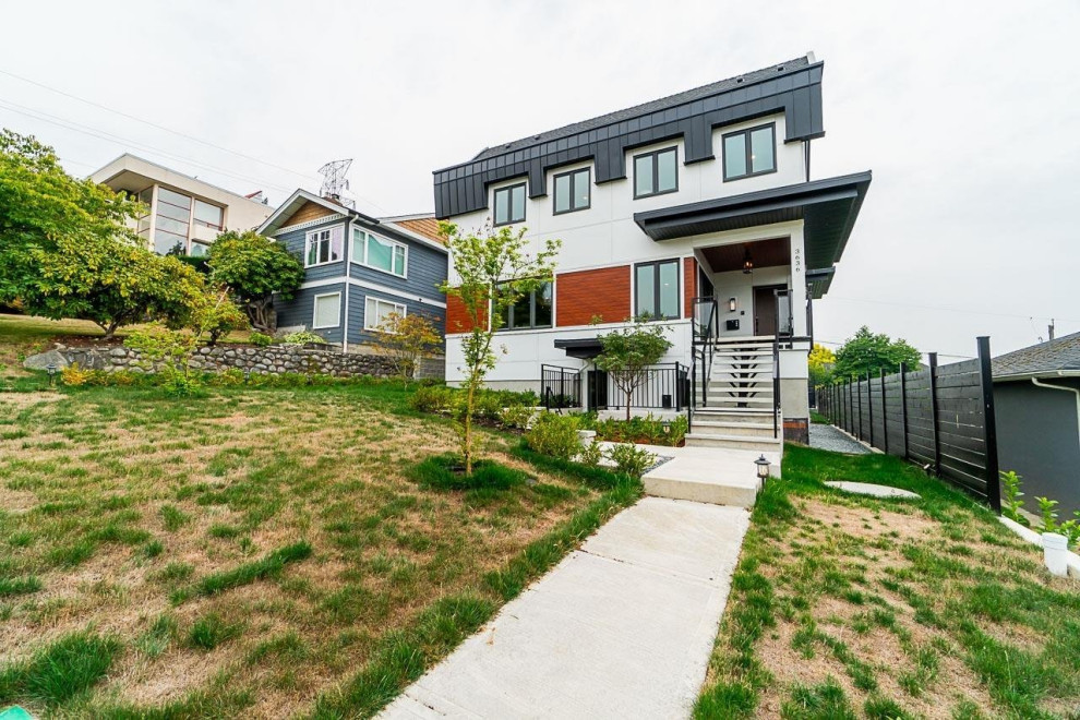 Mid-sized white three-story mixed siding gable roof idea in Vancouver with a shingle roof and a black roof