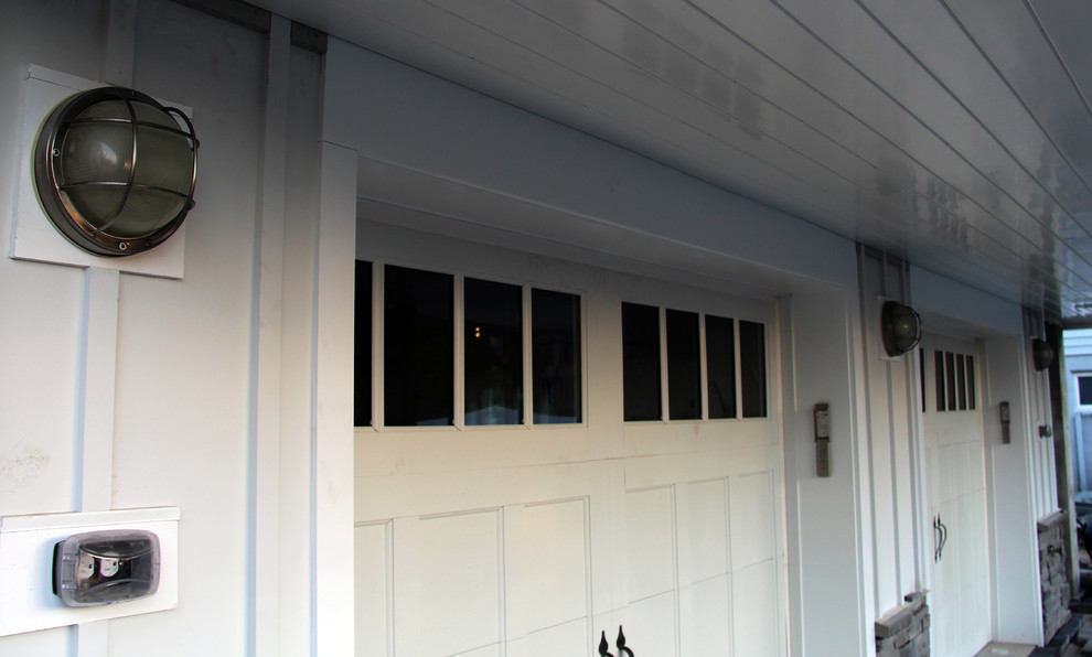 Photo of a large beach style three-storey white exterior in Other with concrete fiberboard siding.