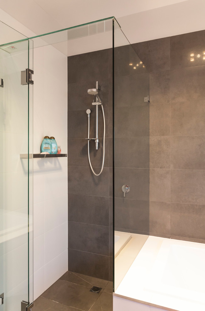 Mid-sized contemporary kids bathroom in Melbourne with a drop-in tub, a corner shower, a two-piece toilet, ceramic tile, white walls, ceramic floors and a vessel sink.