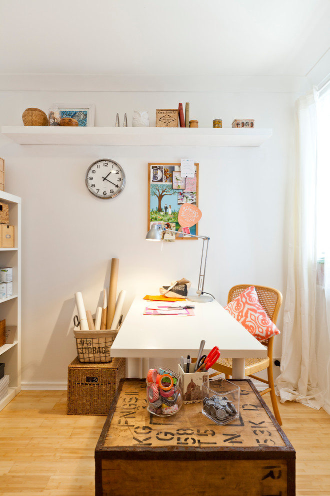 Mid-sized eclectic craft room in Perth with white walls, light hardwood floors and a freestanding desk.