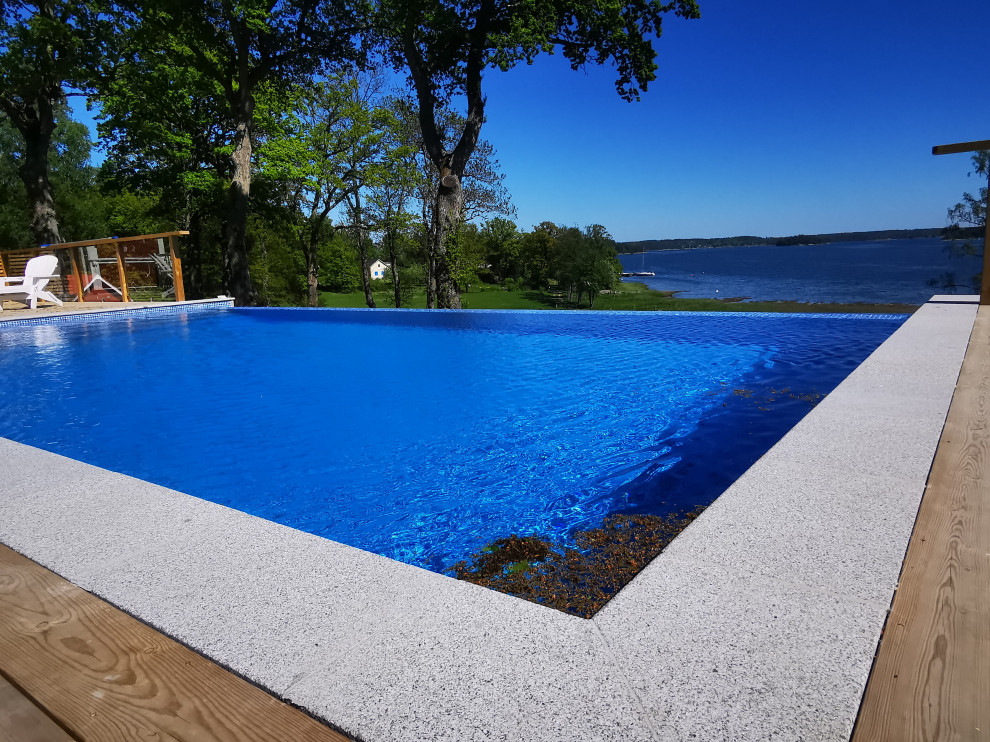 Scandinavian swimming pool in Stockholm with tiled flooring.