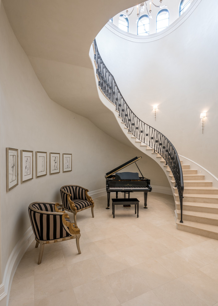 This is an example of an expansive traditional limestone floating staircase in Dallas with limestone risers.