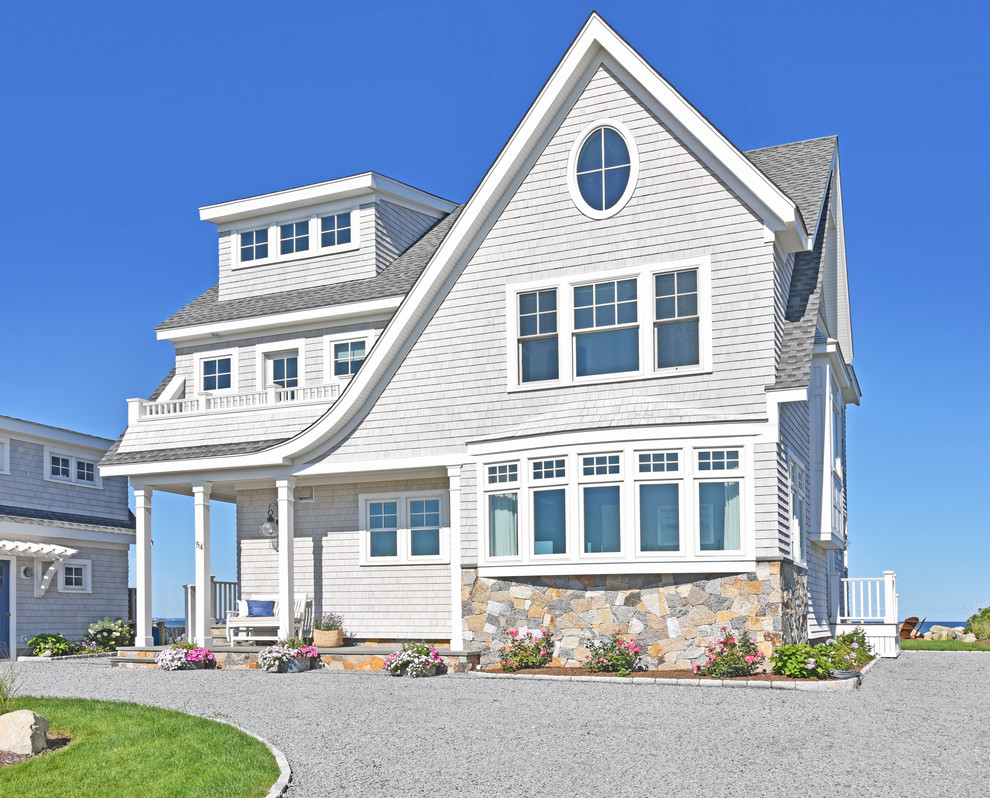 Photo of a mid-sized beach style three-storey grey house exterior in Salt Lake City with mixed siding, a gable roof and a shingle roof.