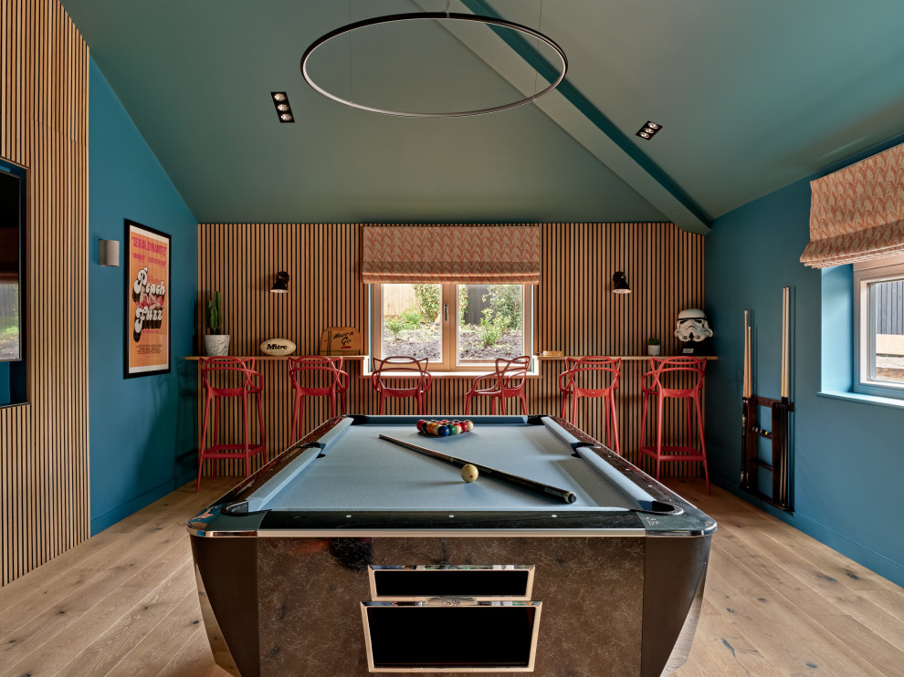 Inspiration for an eclectic games room in Surrey with a feature wall.