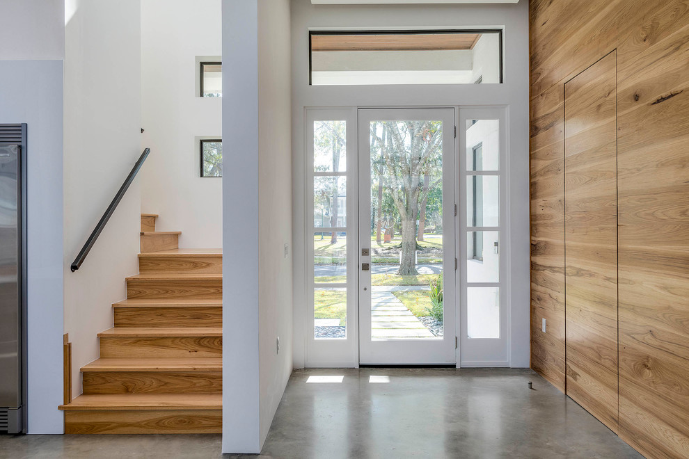 This is an example of a mid-sized modern front door in Orlando with a single front door and a glass front door.