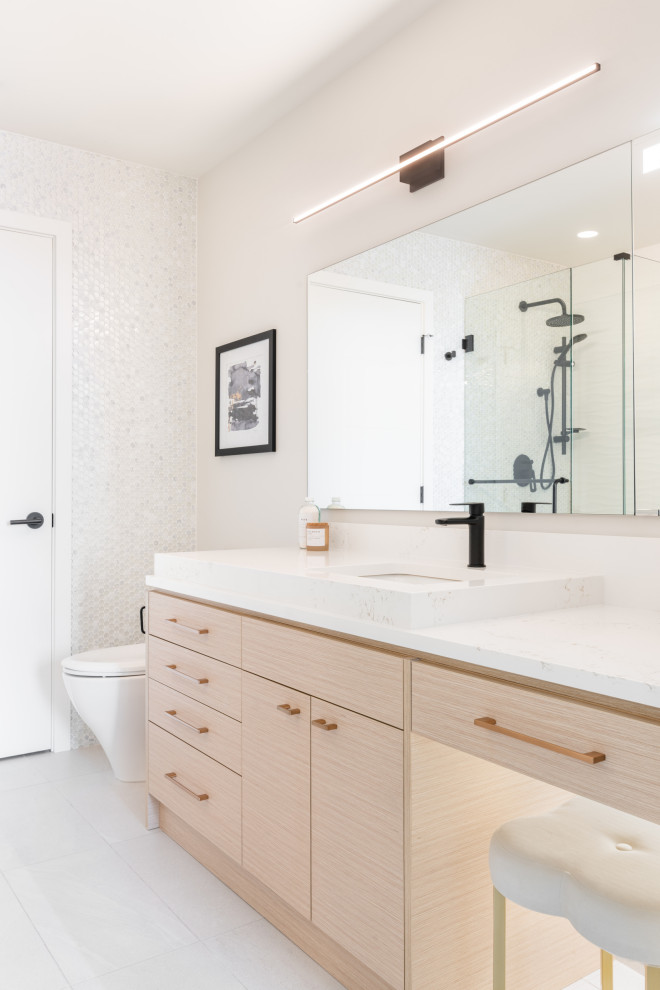 Design ideas for a small contemporary ensuite bathroom in Vancouver with flat-panel cabinets, beige cabinets, an alcove bath, an alcove shower, a two-piece toilet, white tiles, porcelain tiles, white walls, porcelain flooring, an integrated sink, engineered stone worktops, grey floors, a sliding door, white worktops, a single sink and a built in vanity unit.