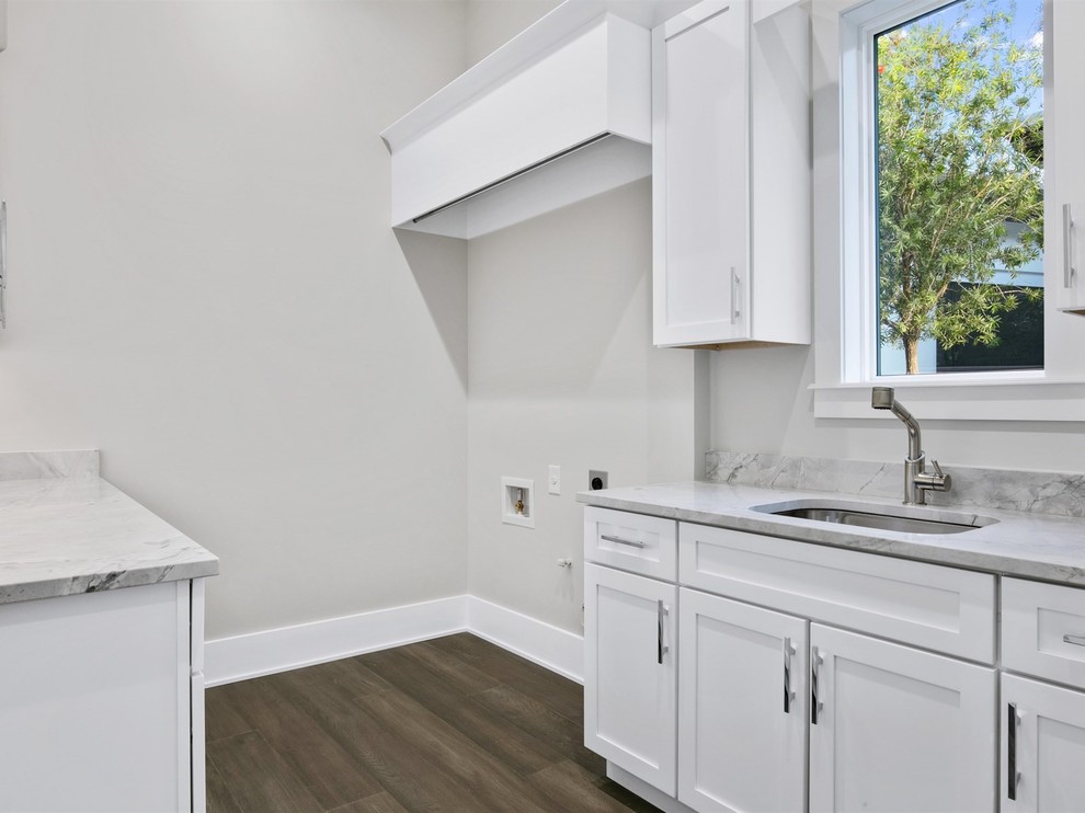 Photo of a small transitional galley dedicated laundry room in Orlando with an undermount sink, shaker cabinets, white cabinets, marble benchtops, grey walls, dark hardwood floors, brown floor and grey benchtop.