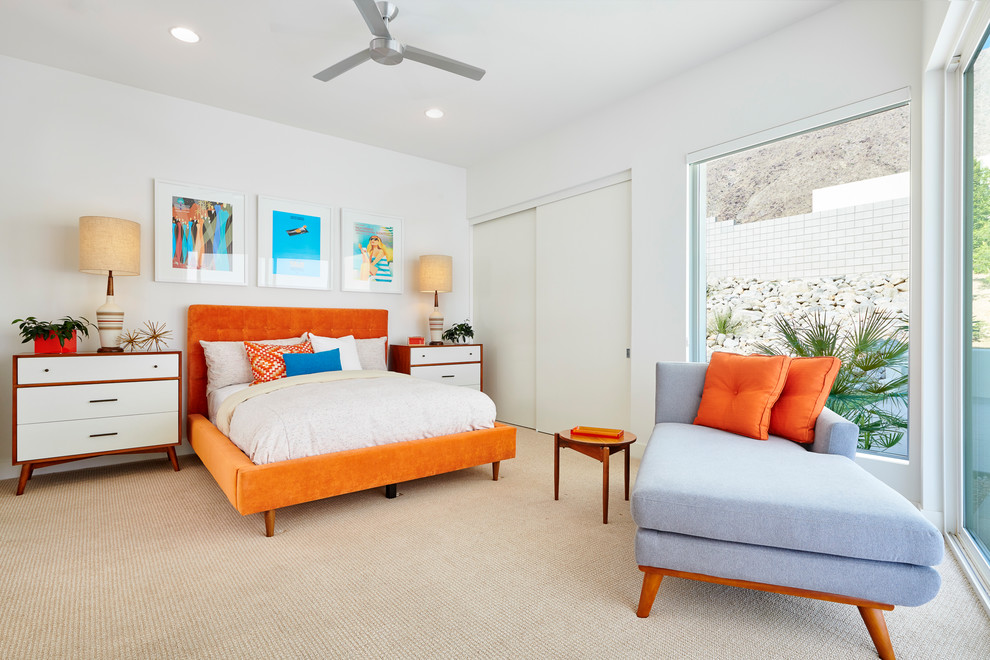 Inspiration for a midcentury bedroom in Orange County with white walls, carpet, no fireplace and beige floor.