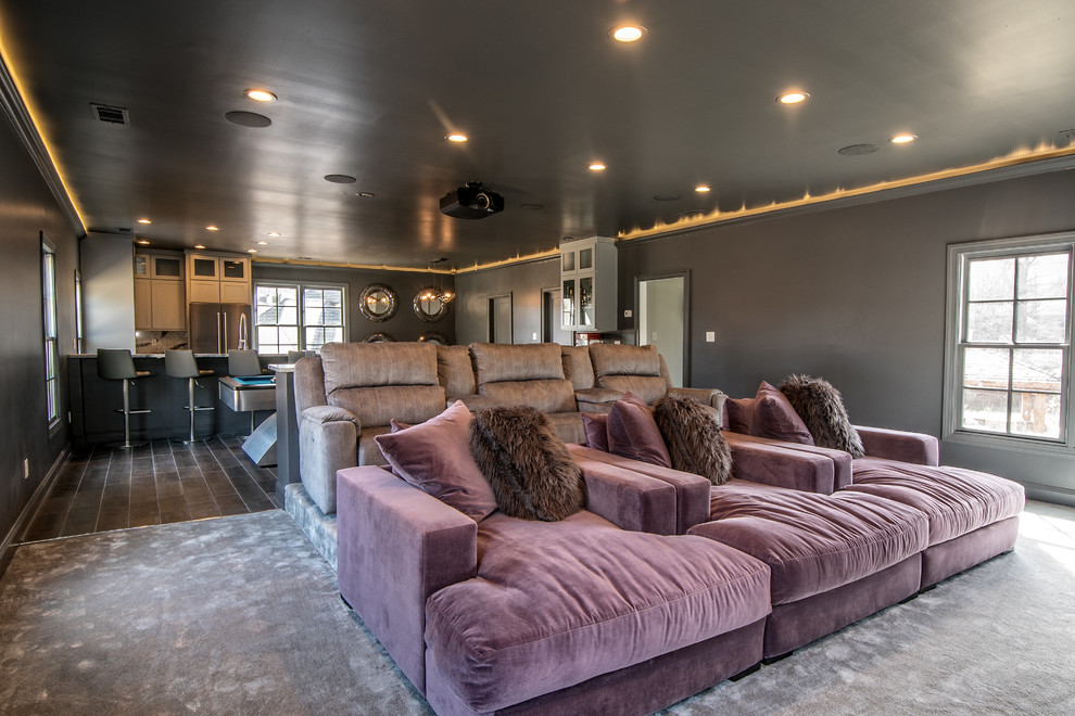 This is an example of a large modern open concept home theatre in Other with grey walls, dark hardwood floors and a wall-mounted tv.