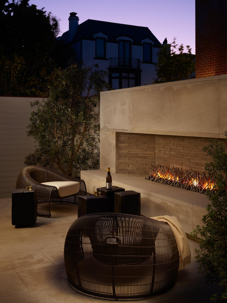 Design ideas for a large contemporary backyard patio in San Francisco with tile, no cover and with fireplace.