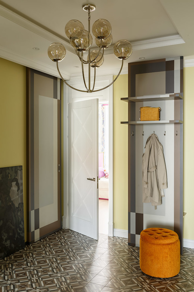 Design ideas for a modern entryway in Saint Petersburg with yellow walls and brown floor.