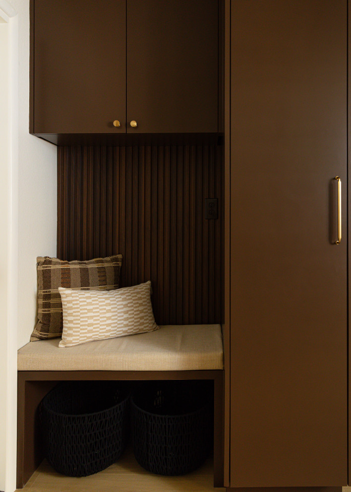 Example of a 1950s utility room design in Portland with flat-panel cabinets, brown cabinets and a stacked washer/dryer