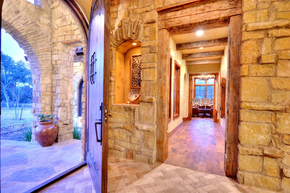 Mountain style foyer photo in Austin with a medium wood front door