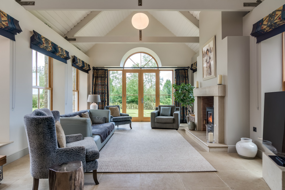 Transitional enclosed living room in Belfast with beige walls, a wood stove, a freestanding tv, beige floor, exposed beam, timber and vaulted.