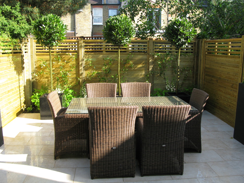 This is an example of a small contemporary backyard full sun garden for summer in London.