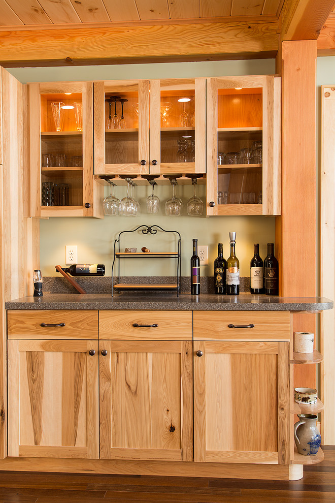 Inspiration for a large rustic u-shaped dark wood floor eat-in kitchen remodel in Burlington with an undermount sink, shaker cabinets, medium tone wood cabinets, solid surface countertops, stainless steel appliances and an island