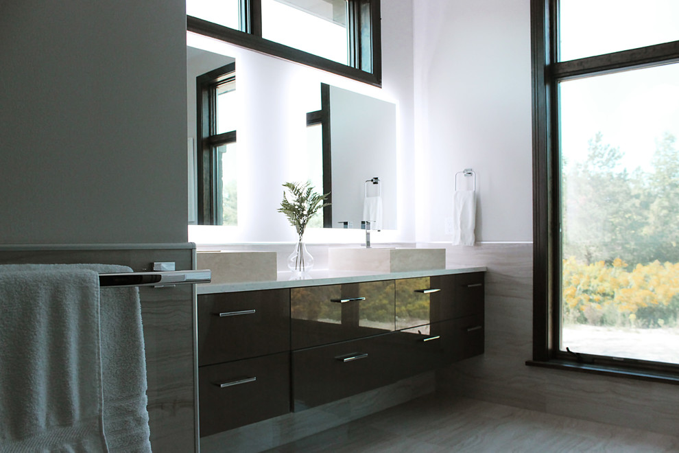 This is an example of a mid-sized contemporary master bathroom in New York with flat-panel cabinets, brown cabinets, beige tile, stone tile, white walls, a vessel sink, engineered quartz benchtops, beige floor and white benchtops.