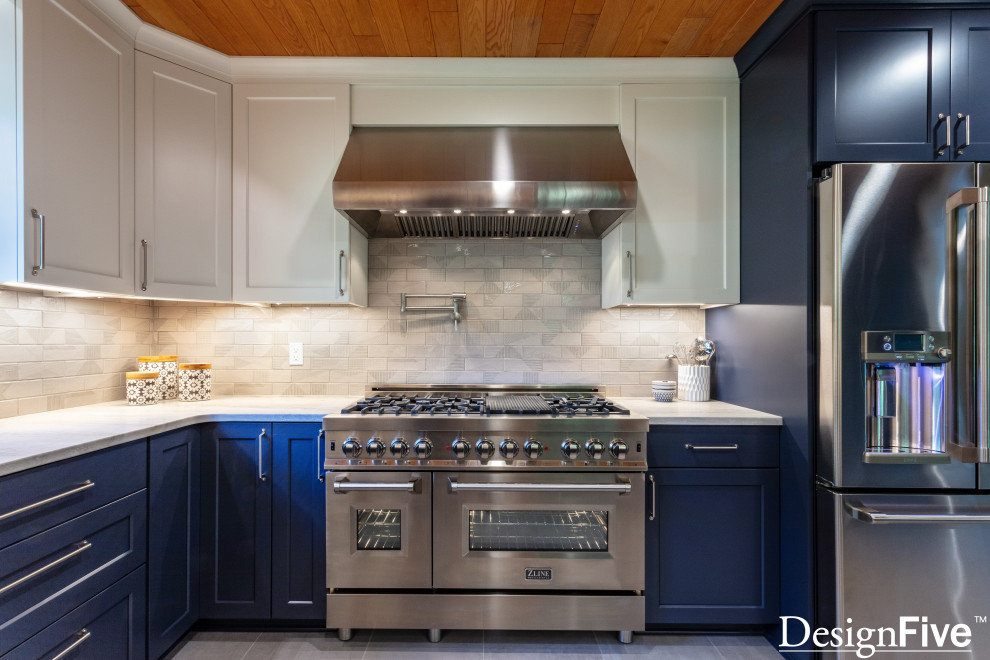 Large minimalist u-shaped gray floor and wood ceiling open concept kitchen photo with an undermount sink, shaker cabinets, blue cabinets, quartz countertops, gray backsplash, ceramic backsplash, stainless steel appliances and no island