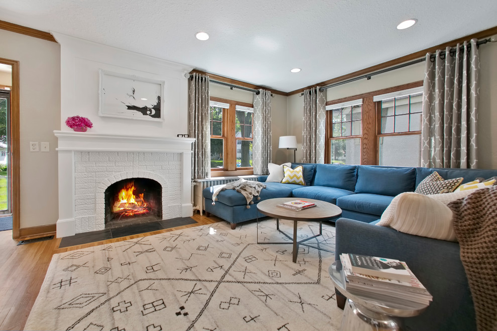 Mid-sized transitional formal enclosed living room in Minneapolis with beige walls, medium hardwood floors, a standard fireplace and a brick fireplace surround.
