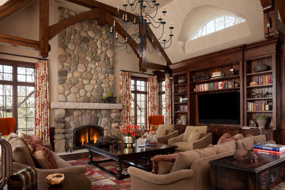 Traditional formal living room in Detroit with beige walls, a standard fireplace, a stone fireplace surround and a built-in media wall.