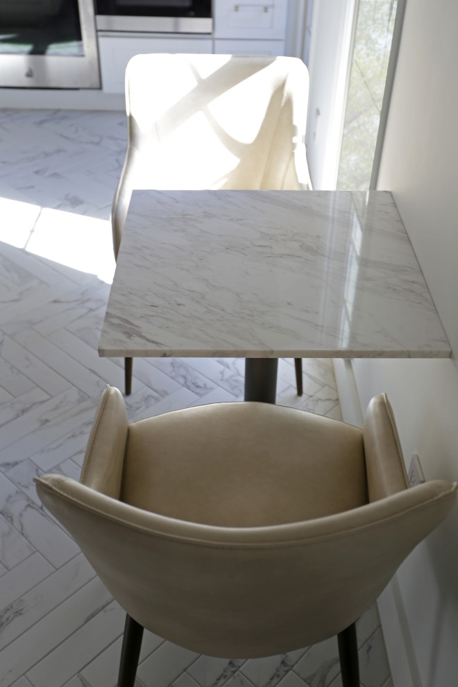 Inspiration for a mid-sized transitional l-shaped marble floor, white floor and exposed beam kitchen remodel in DC Metro with an undermount sink, shaker cabinets, white cabinets, quartzite countertops, white backsplash, quartz backsplash and stainless steel appliances